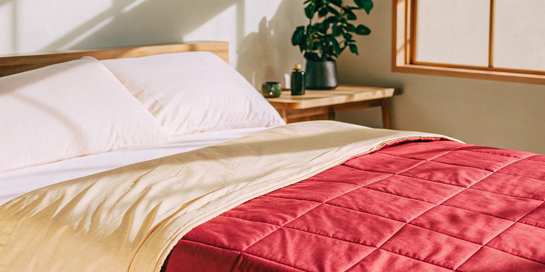 A 20 lbs twin weighted blanket neatly laid out on a bed.