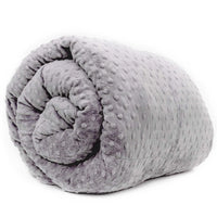 A grey minky weighted blanket rolled up, showcasing its soft, velvety texture.