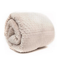 A light beige latte colored minky weighted blanket rolled up, showcasing its soft, velvety texture.