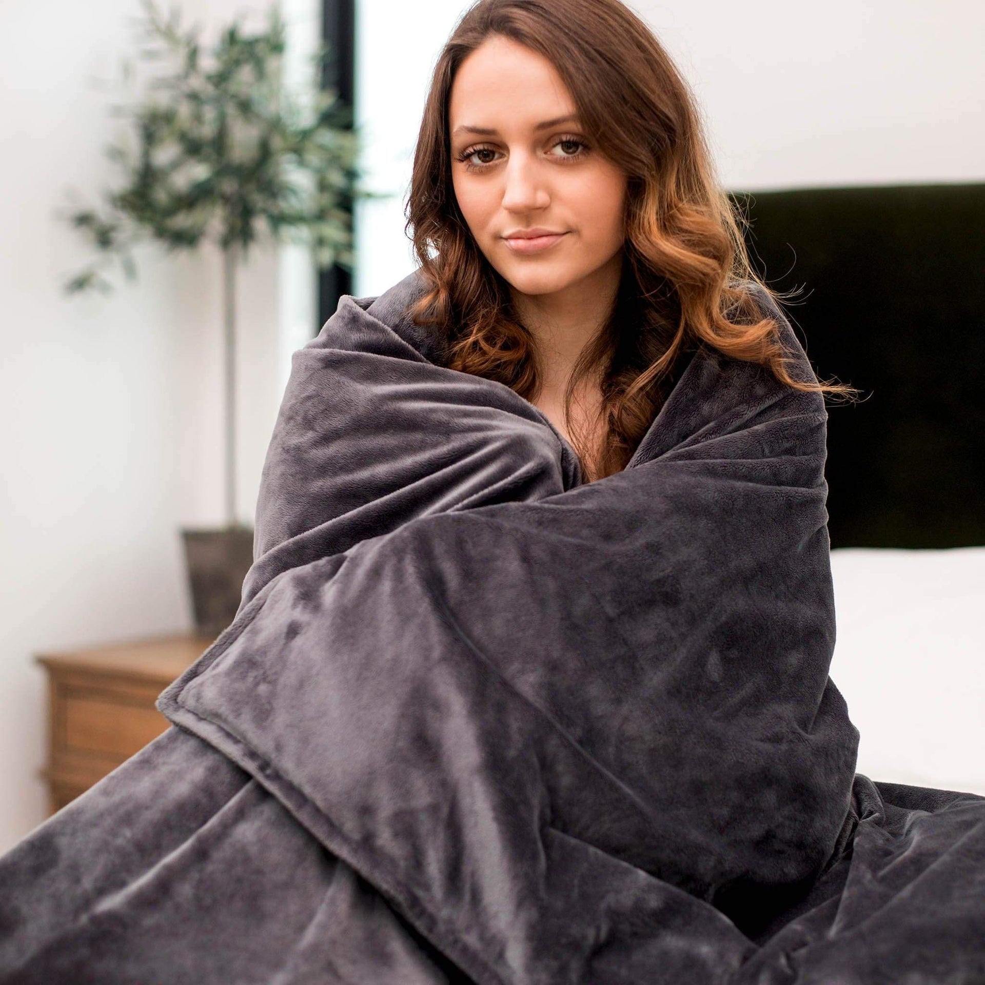 Woman wrapped in her Charcoal Gray Plush Duvet Cover