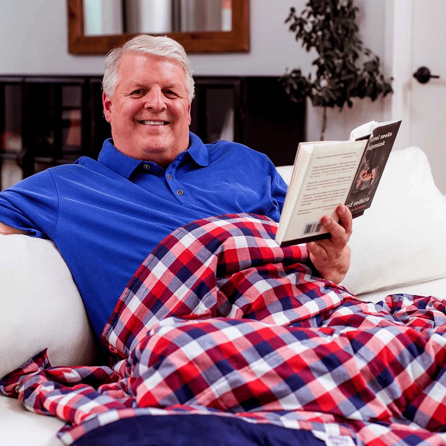 Handsome man with a Mosaic Weighted Blankets Americana Weighted Blanket in Red White Blue Plaid