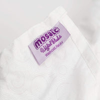 Mosaic Weighted Blankets made in America logo tag on the Blanca White Weighted Blanket