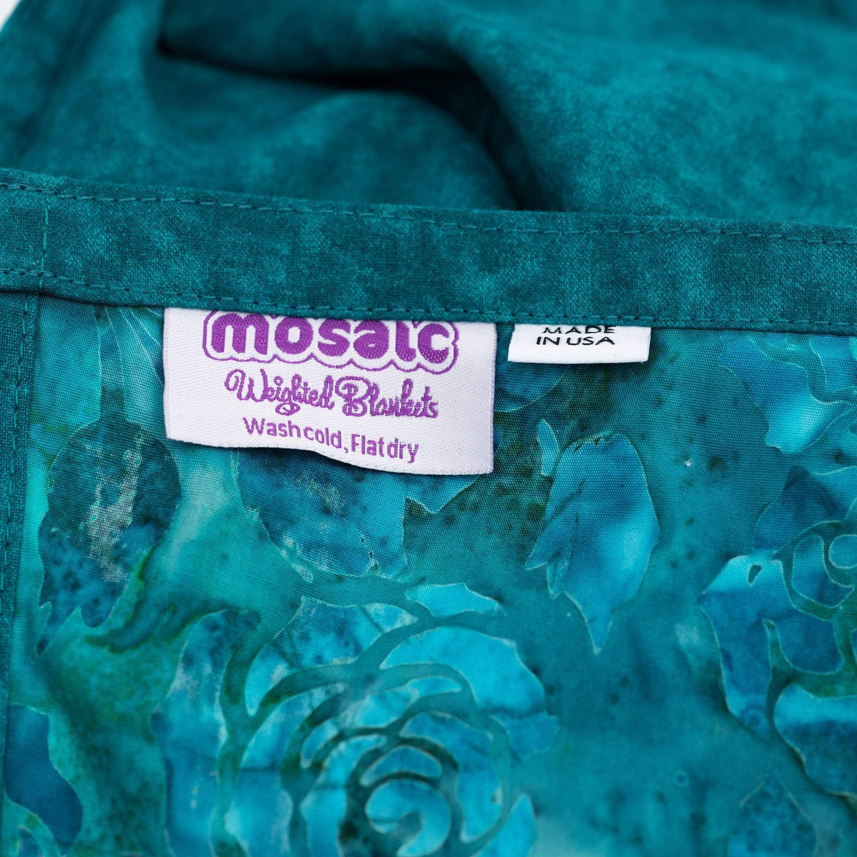 Closeup of the Made in America tag of the Mosaic Weighted Blankets Green Roses Weighted Blanket