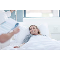 Hospital patient snuggled under her Hospital Grade Anti-Microbial Blankets with Cover