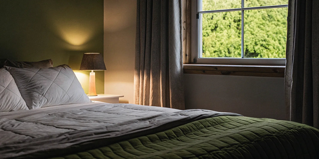 One of the best cotton weighted blankets made in the USA, neatly placed on a bed.