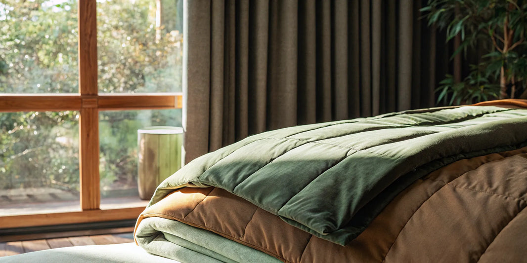 The best weighted blanket for anxiety and panic attacks resting on a calm, sunlit bed.