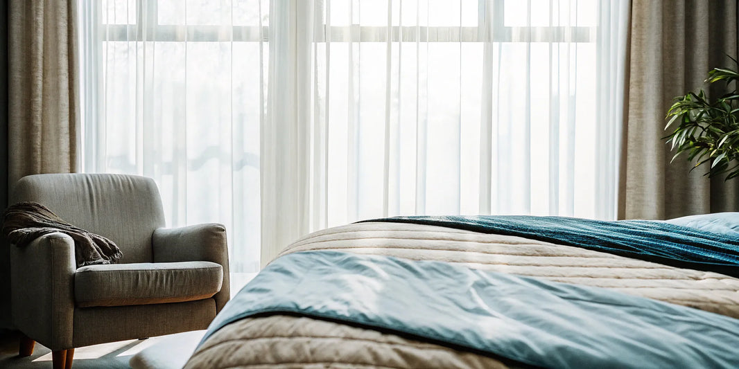 A weighted blanket with a stylish design draped over a bed in a modern bedroom.