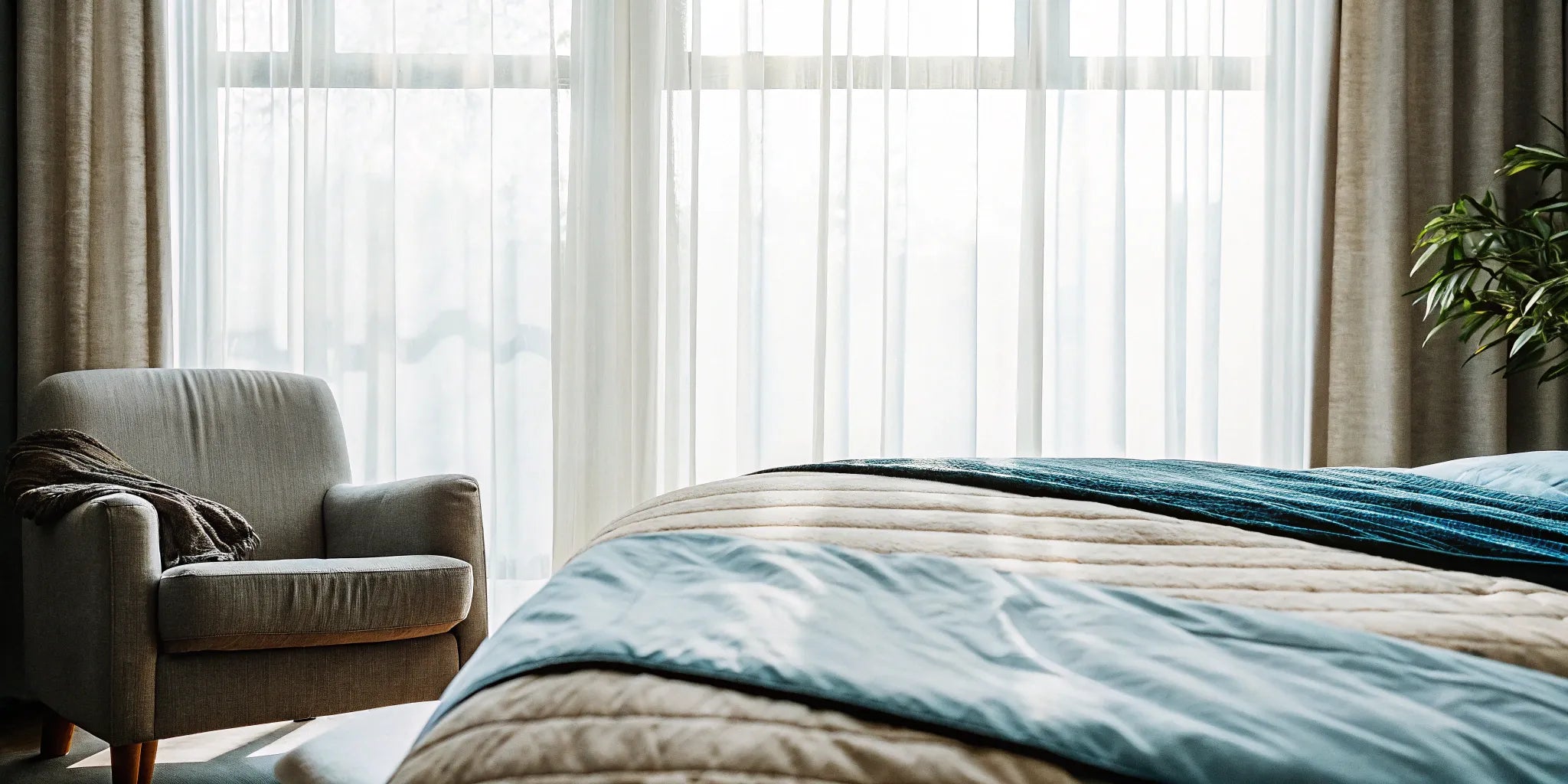 A weighted blanket with a stylish design draped over a bed in a modern bedroom.