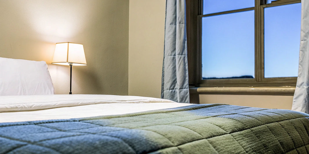 One of the best anxiety blankets on a cozy bed, creating a calm setting for restful sleep.