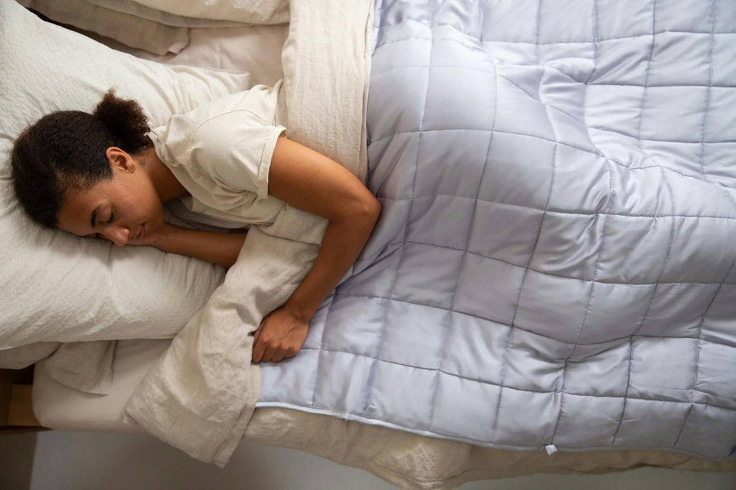 Woman Sleeping in Bed With Weighted Blanket