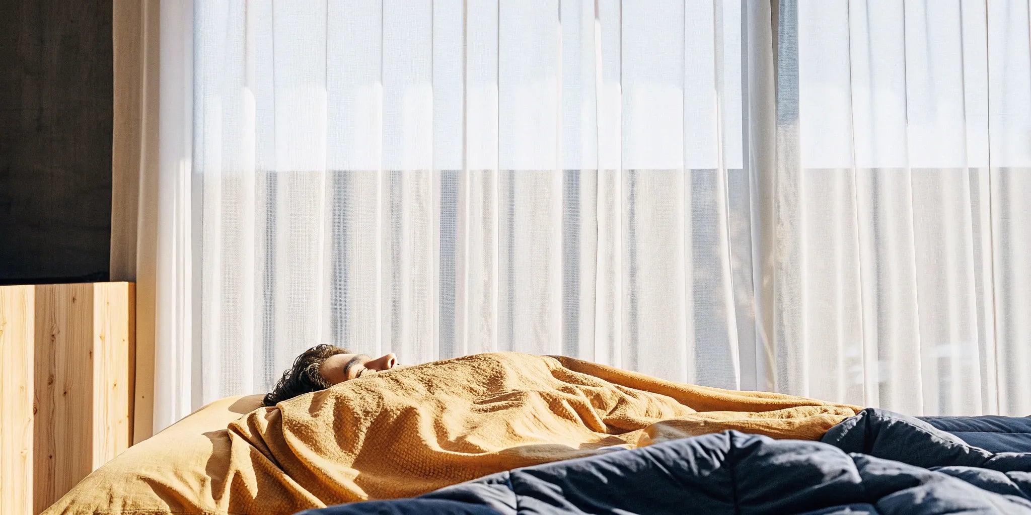 A person sleeping comfortably with a custom size and weight blanket.