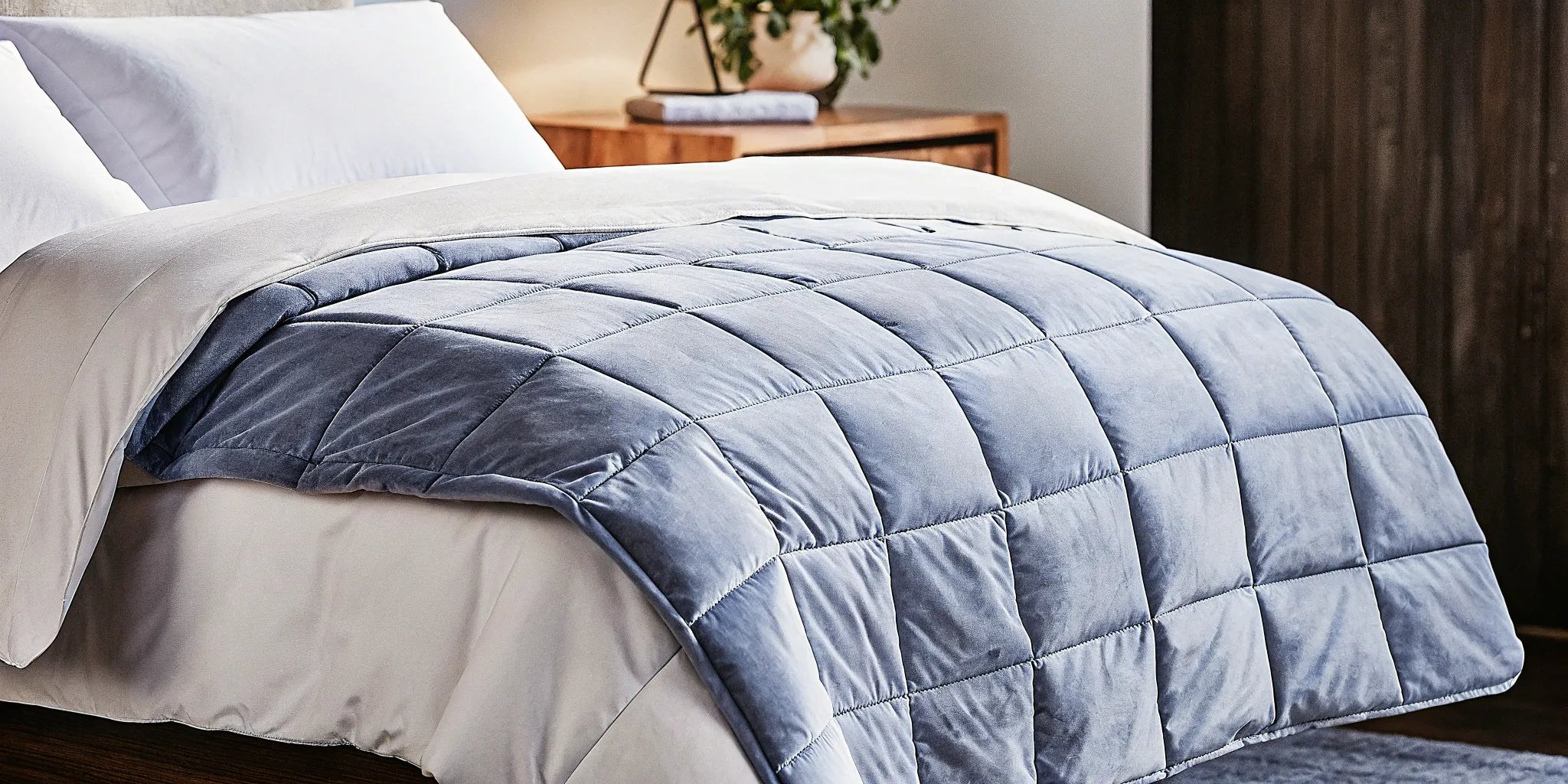 A twin 20 lb weighted blanket on a neatly made bed.