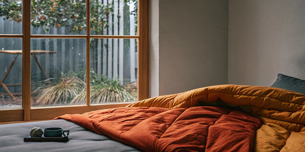 A weighted blanket on a bed, a good tool for calming anxiety and improving sleep.