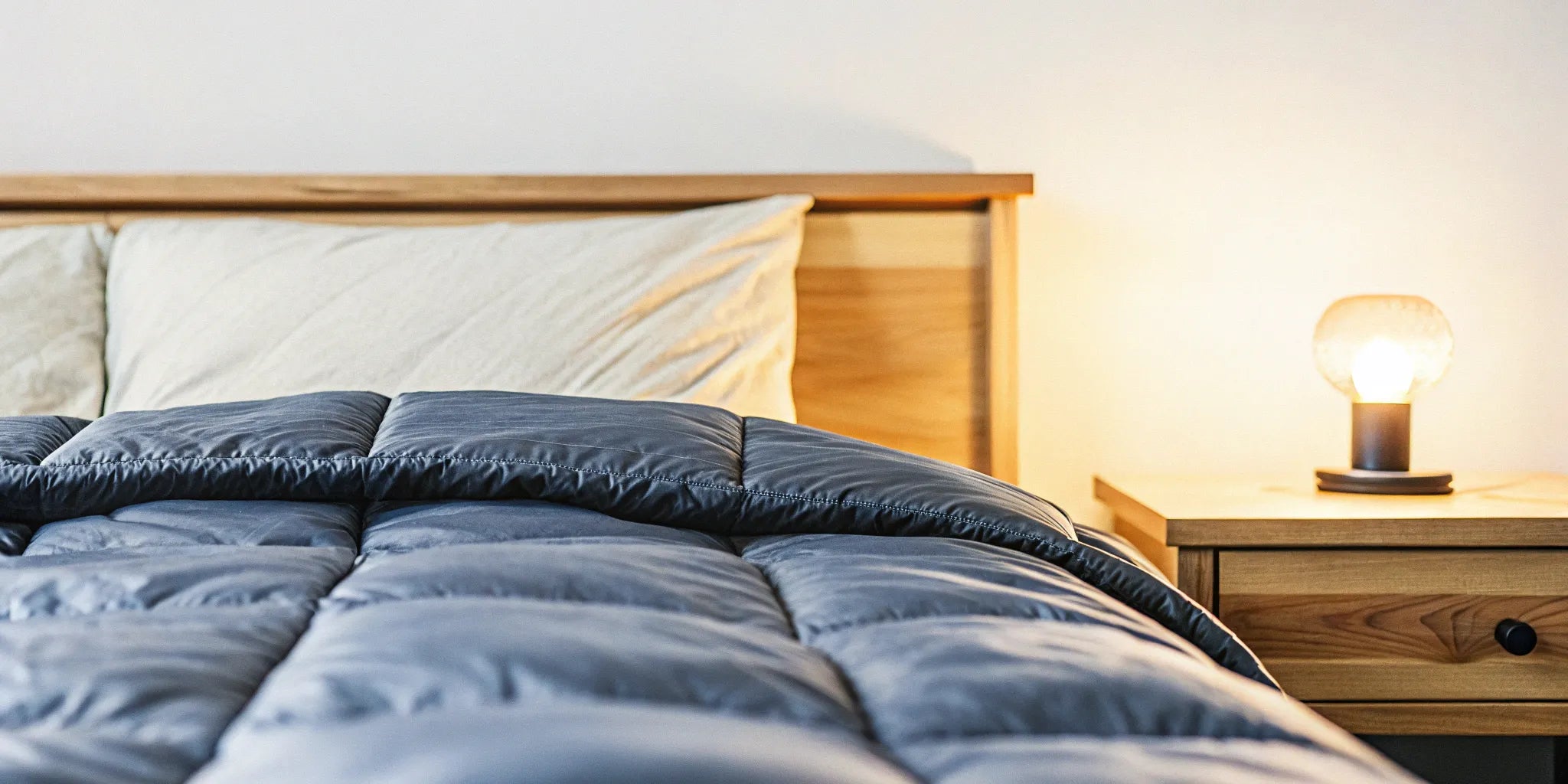 A top-rated 15 lb weighted blanket, 60x80, neatly folded on a comfortable bed.