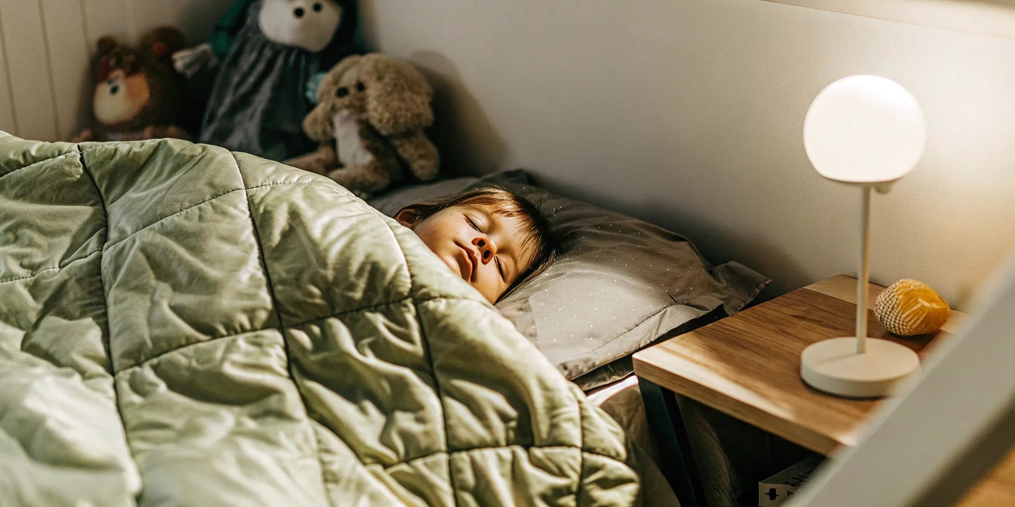 A child sleeping soundly under a kids sensory blanket, a popular choice for parents to buy online.