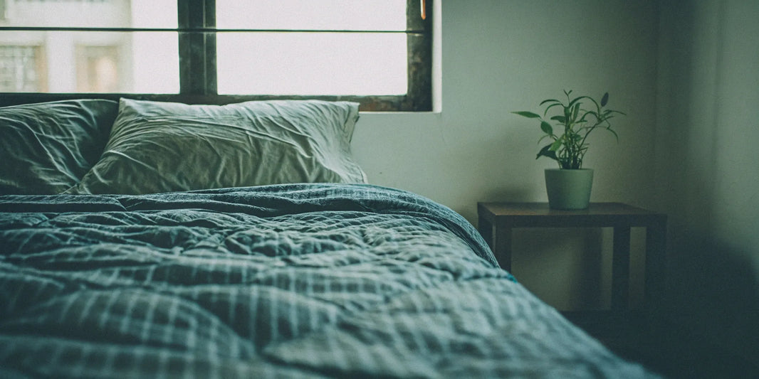 Washable weighted blanket on a bed.