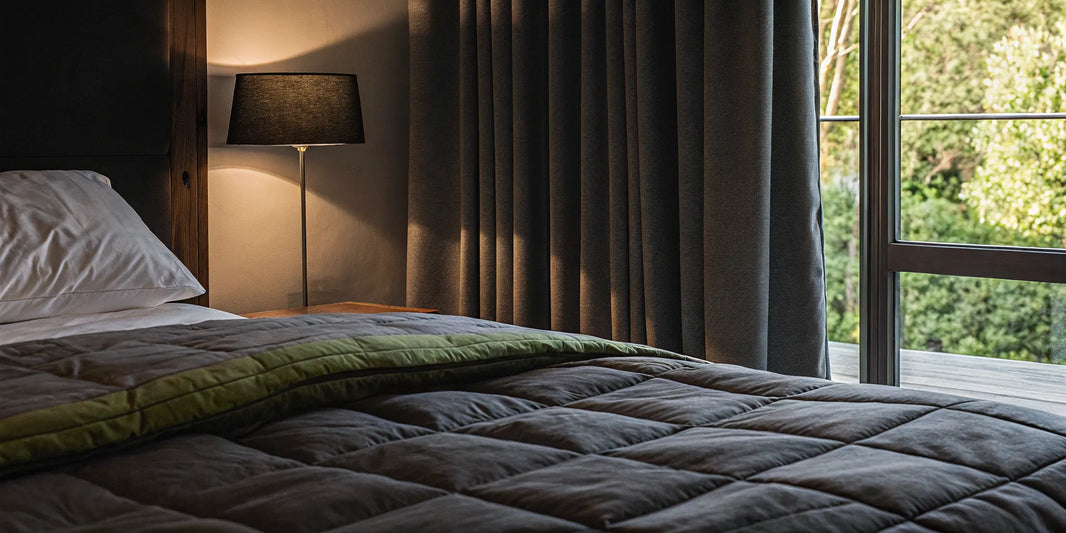 A 20 lb queen weighted blanket on a bed in a cozy, sunlit bedroom.