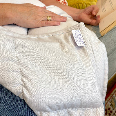 close up of weighted lap pad while someone reads.