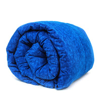 A rolled up weighted blanket in a navy blue color, showing a textured pattern.