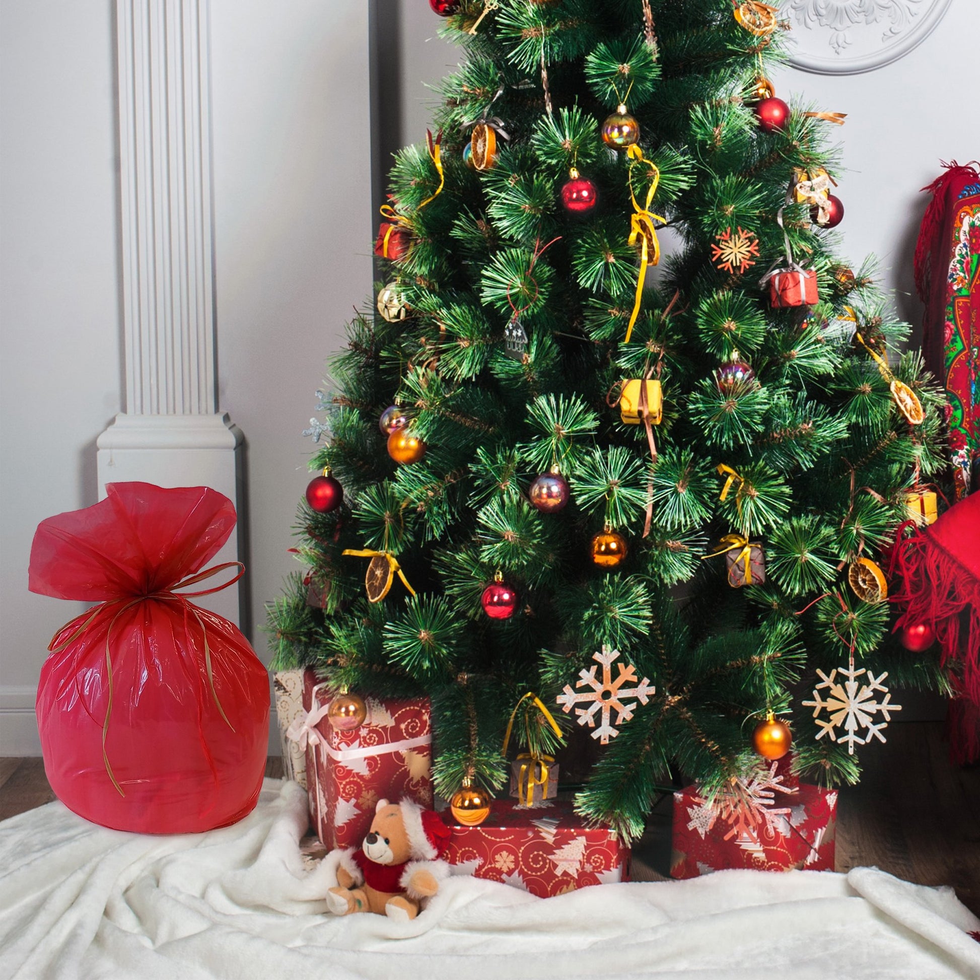 A red Santa's Present Bag under the Christmas tree