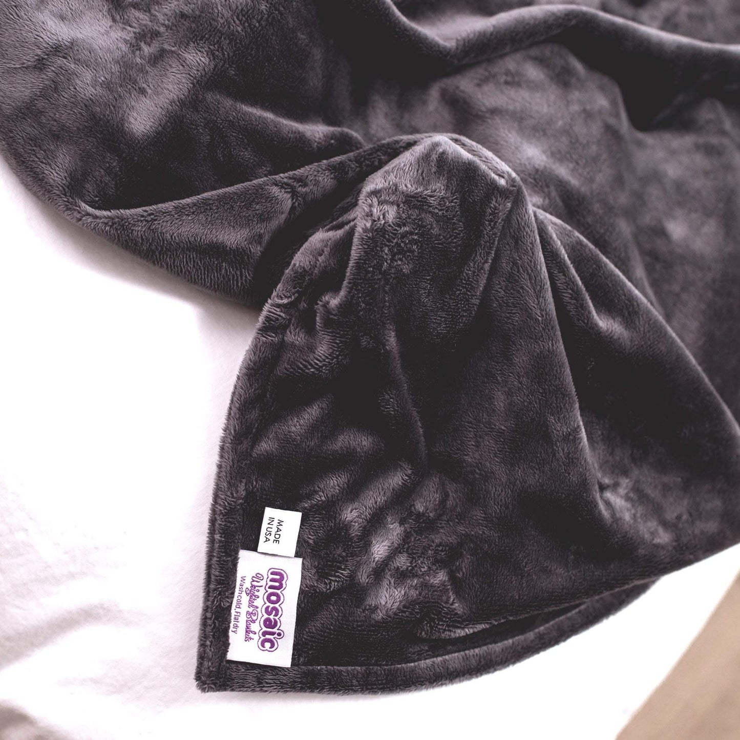 Closeup of the Charcoal Gray Plush Duvet Cover and tag