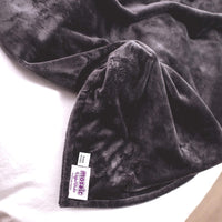 Closeup of the Charcoal Gray Plush Duvet Cover and tag