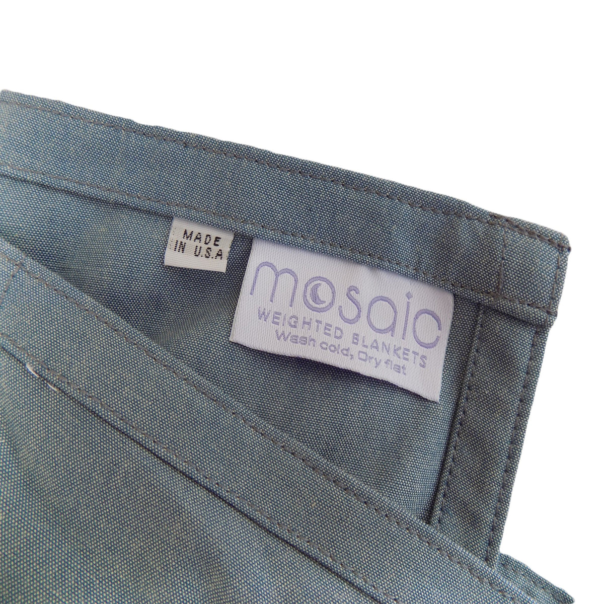Close up of Mosaic Weighted Blankets Comfy Chambray Weighted Blanket and Made in America tags