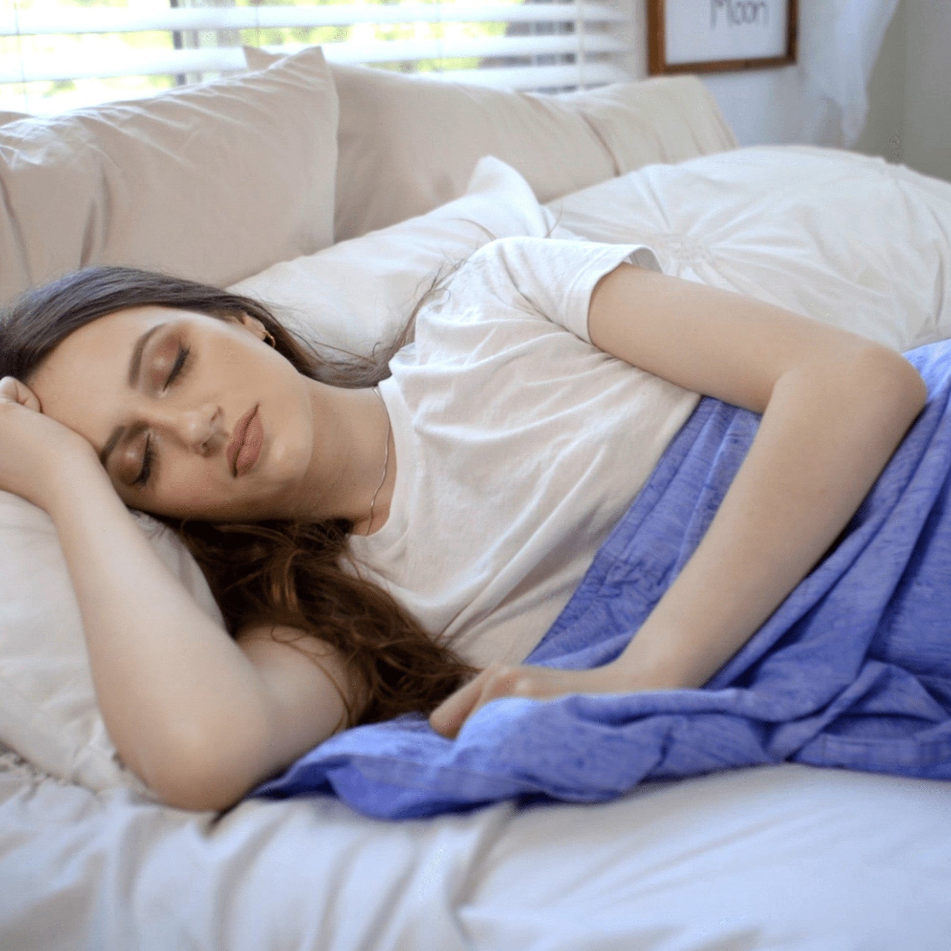Woman snuggled under her Mosaic Weighted Blankets Indigo Purple Weighted Blanket in bed