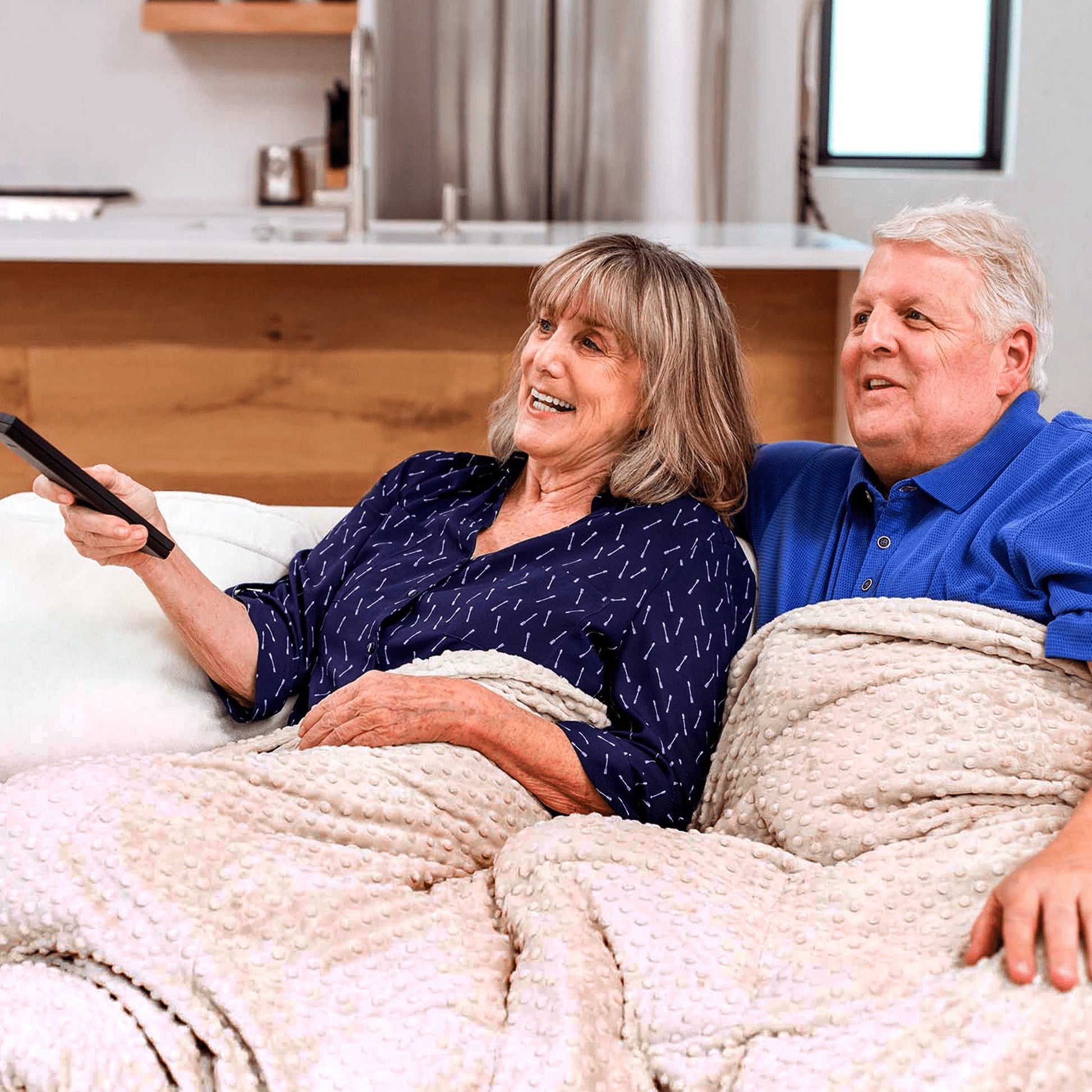 Couple snuggle under their Mosaic Weighted Blankets Latte Minky Weighted Blanket in bed
