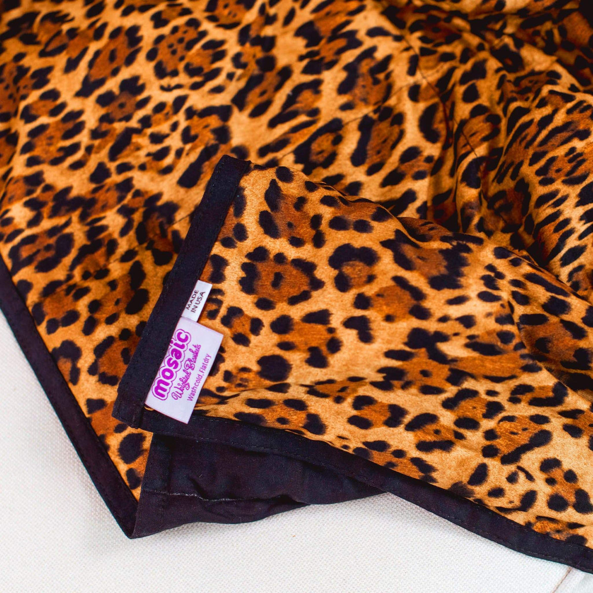 Close up of the tags and patter of a Mosaic Weighted Blankets Leopard Weighted Blanket