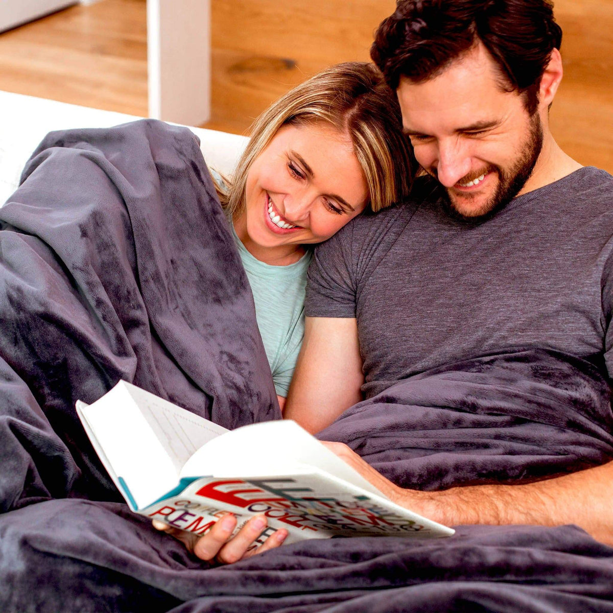 Couple snuggled under their Organic Cotton Weighted Blanket And Plush Duvet in bed