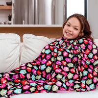 Woman snuggled on the couch under her Mosaic Weighted Blankets Owls Weighted Blankets