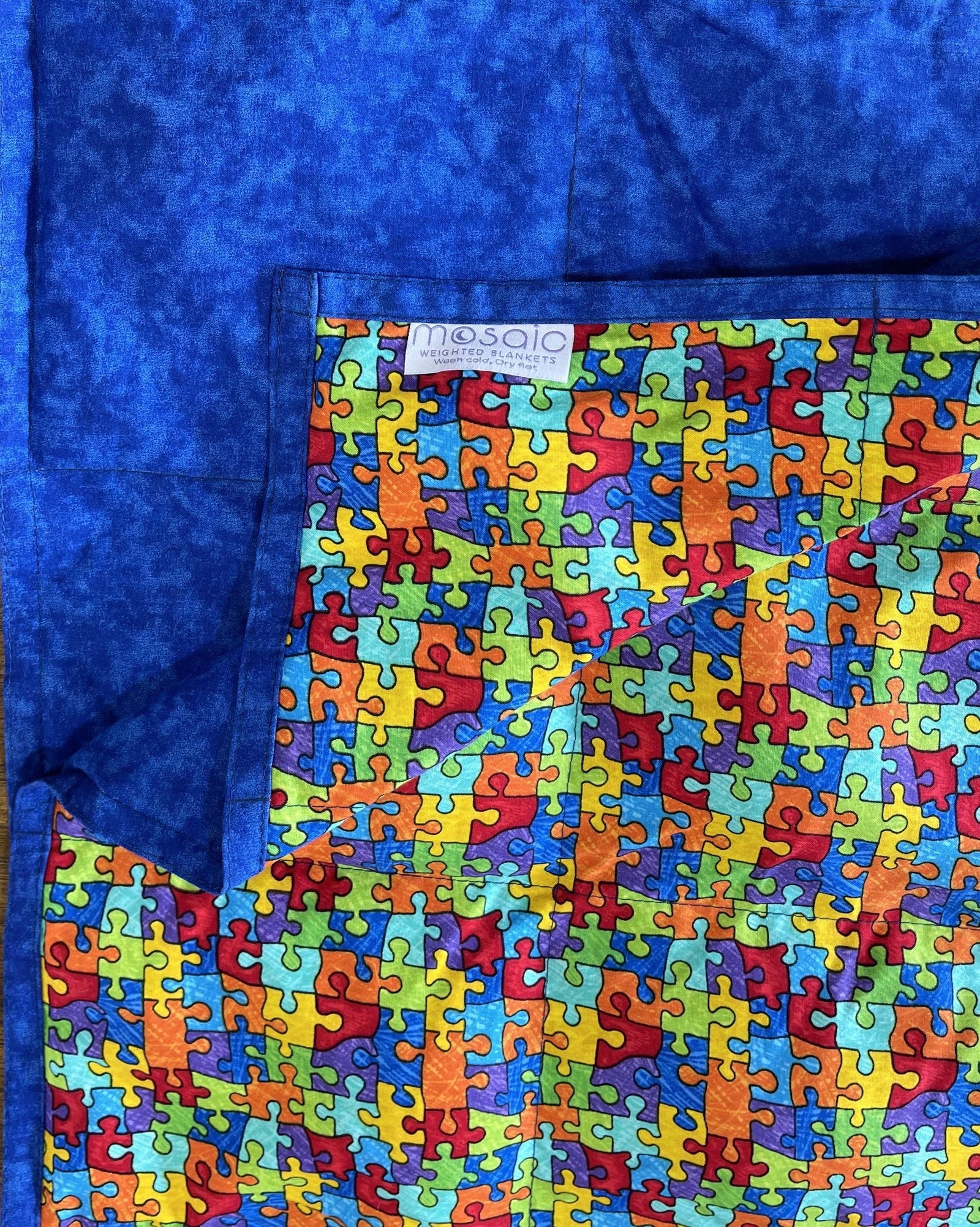 Puzzle Pieces Weighted Blanket Rolled Side View