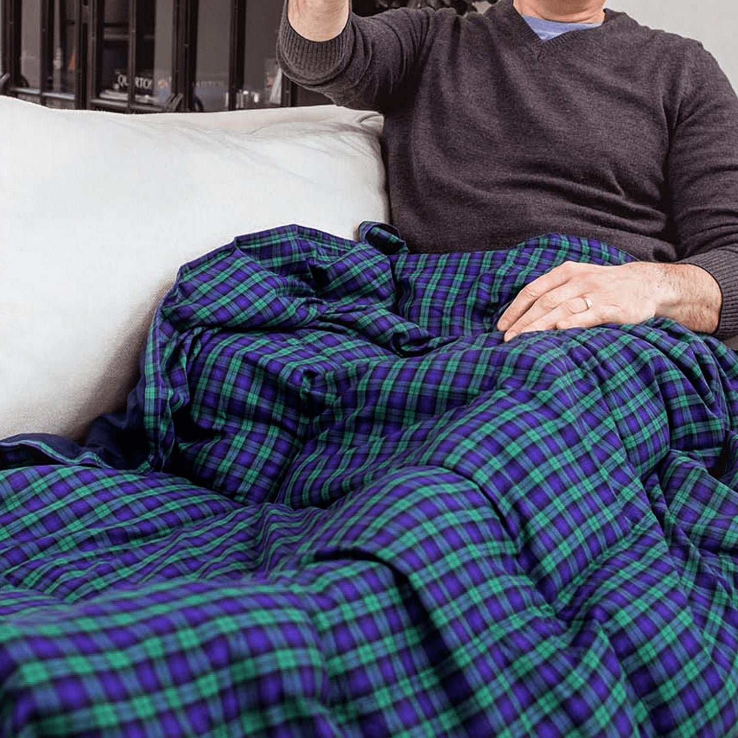 Man sitting under his Mosaic Weighted Blankets Scottish Navy Plaid Weighted Blanket